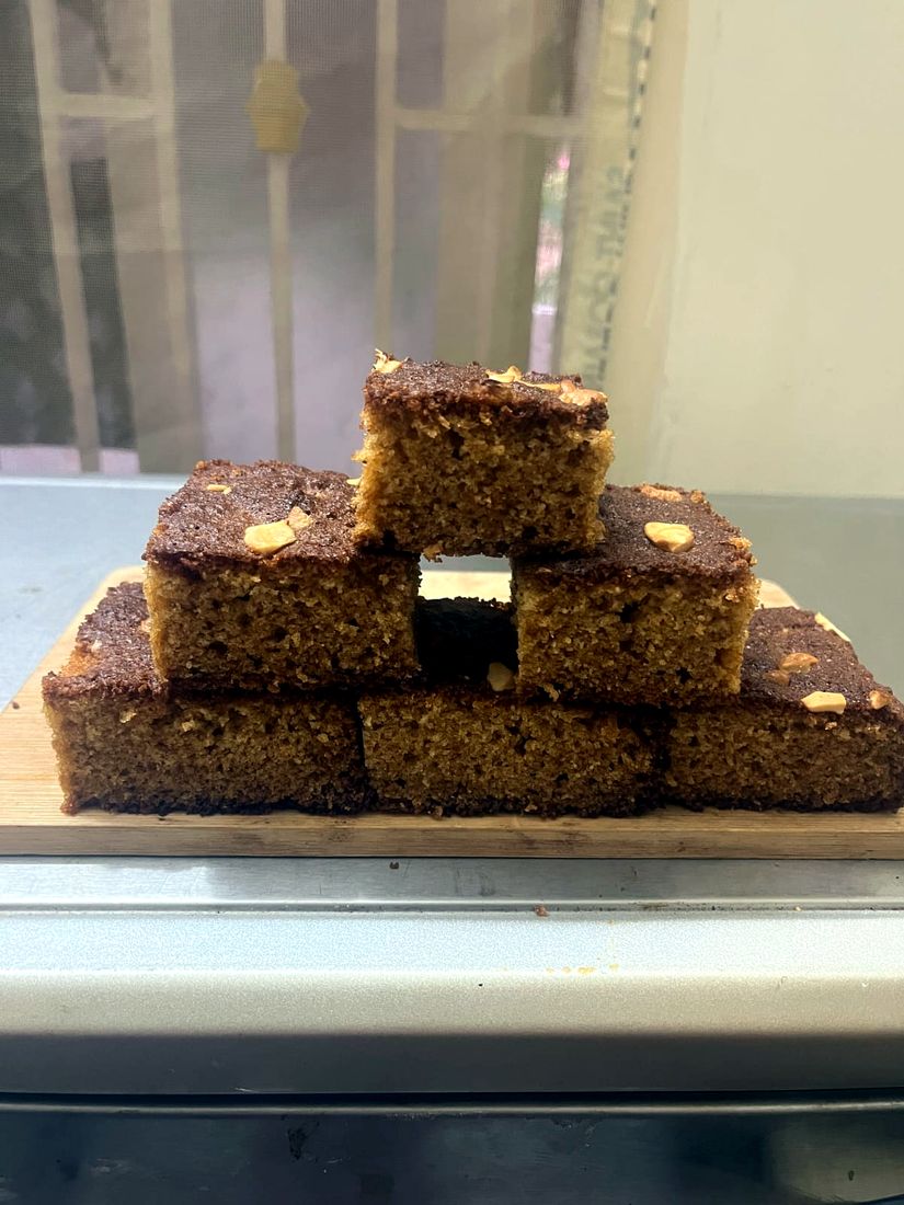 Golden wheat tea cake squares stacked on a board