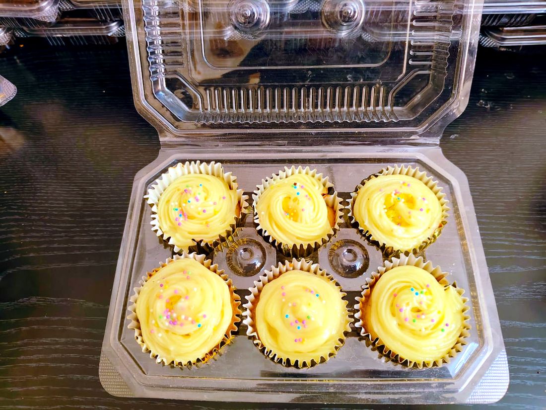 Box of six vanilla cupcakes with sprinkle frosting