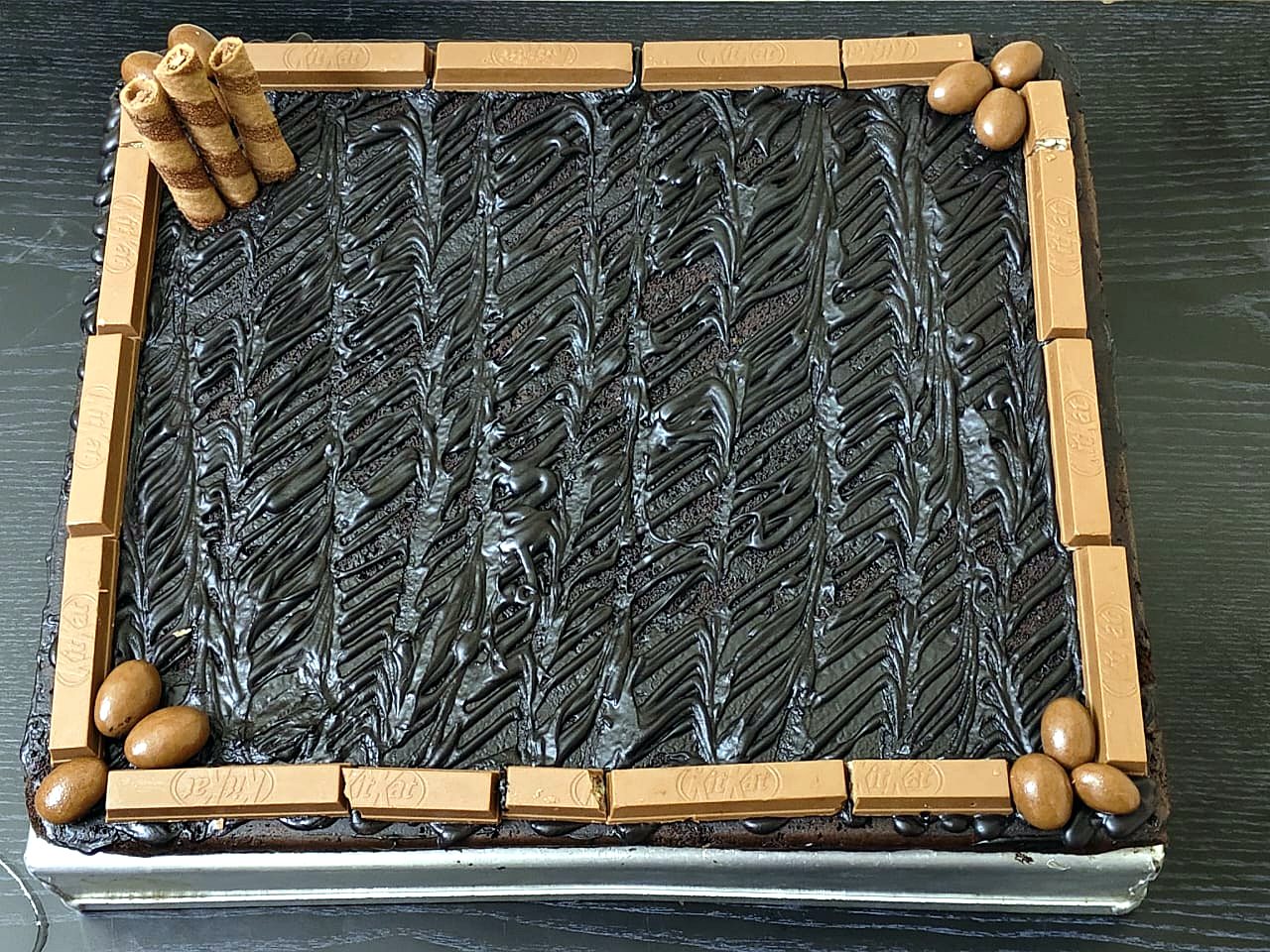 Death by Chocolate slab cake bordered with KitKat fingers, chocolate eggs and wafer rolls